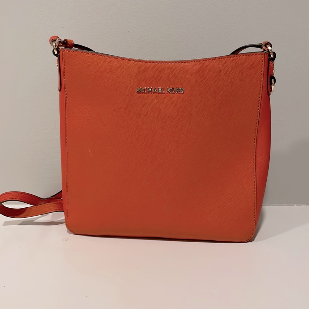 Michael Kors orange handbag.